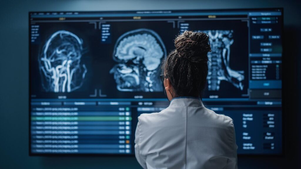 Doctor looks brain scans on MRI film on light box